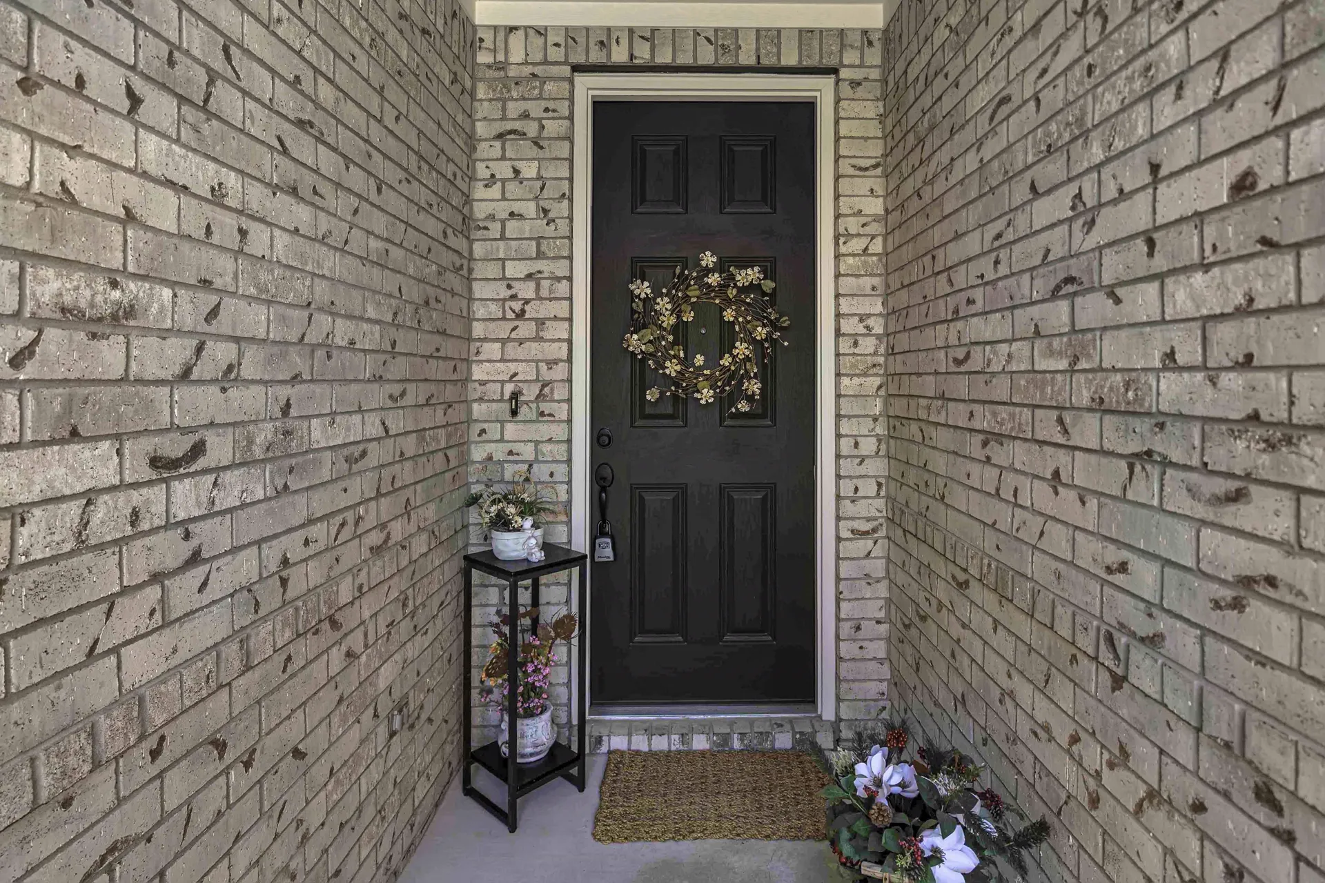Front door with stone surround, lantern and welcoming entry
