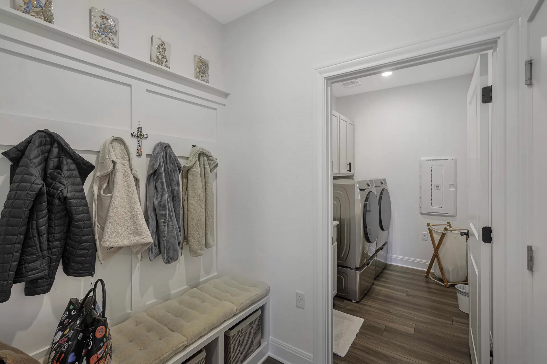 Mudroom entry with bench seating and organized hooks
