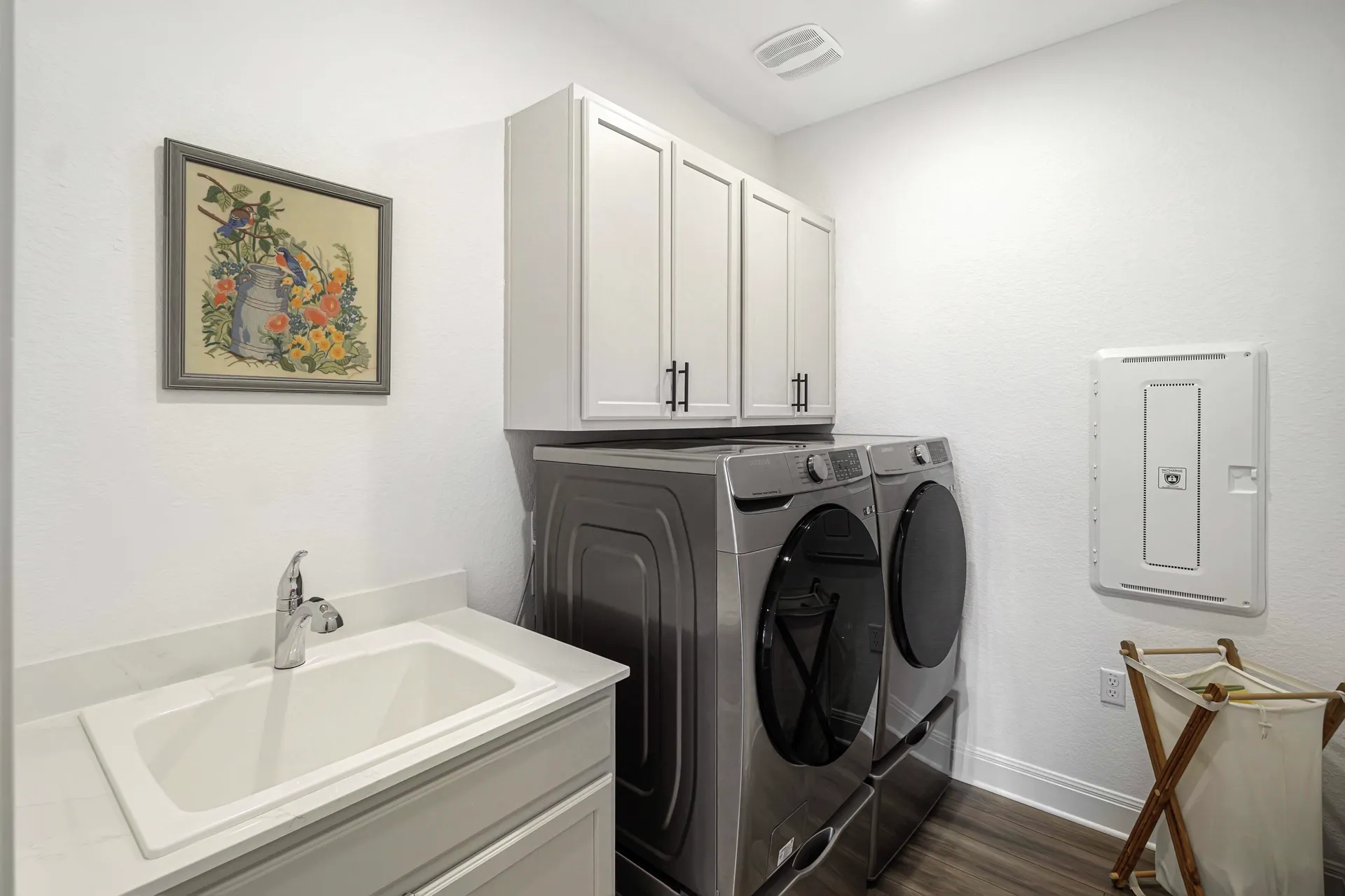 Laundry room — wider view with overhead cabinets