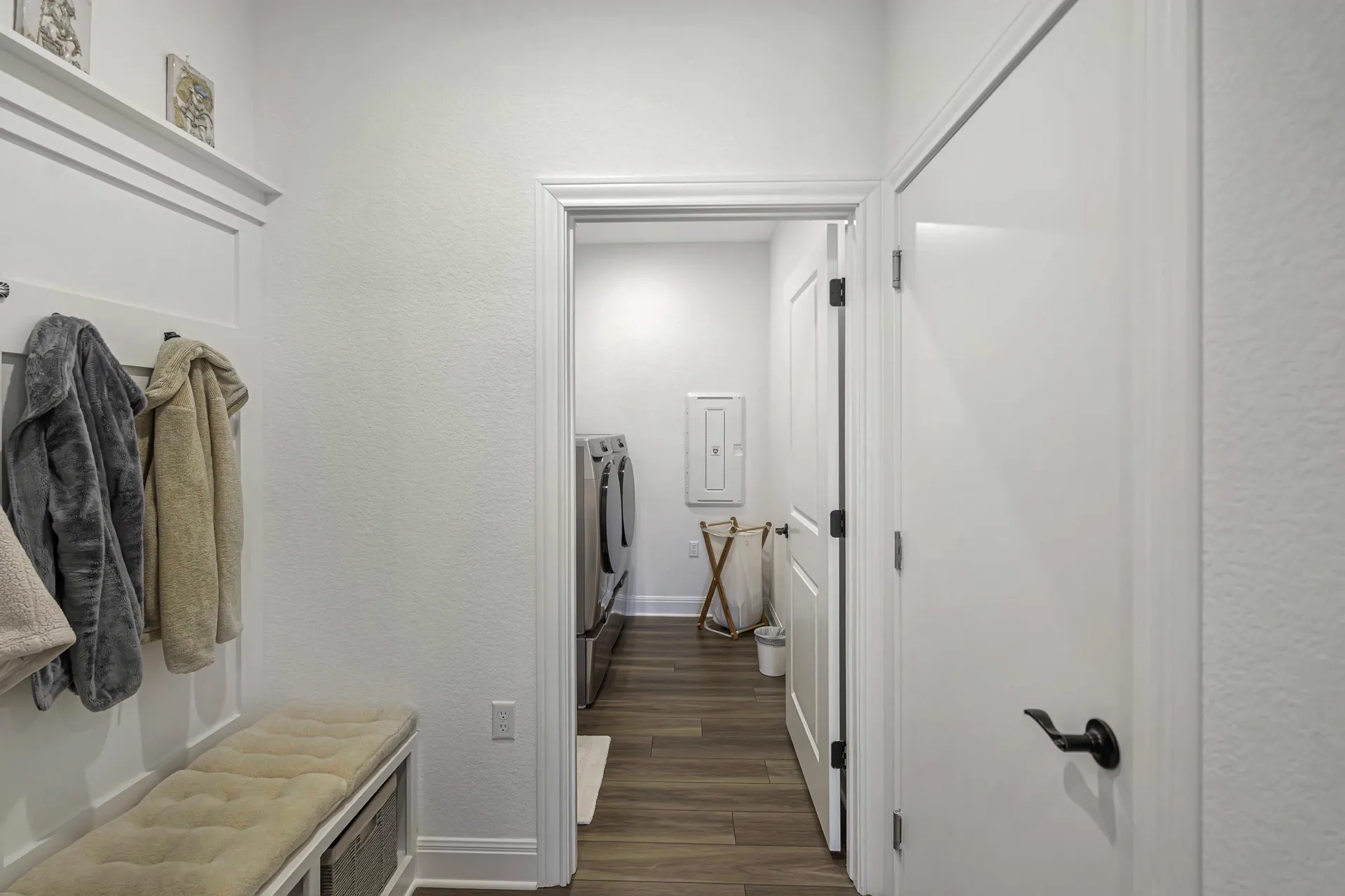 Mudroom coat closet with built-in hooks and bench