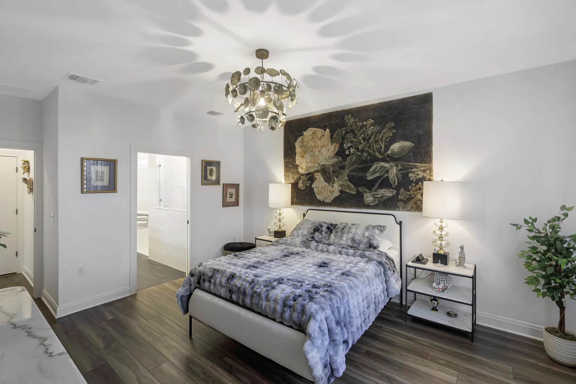 Primary bedroom — designer bedding, mirrored nightstands and art