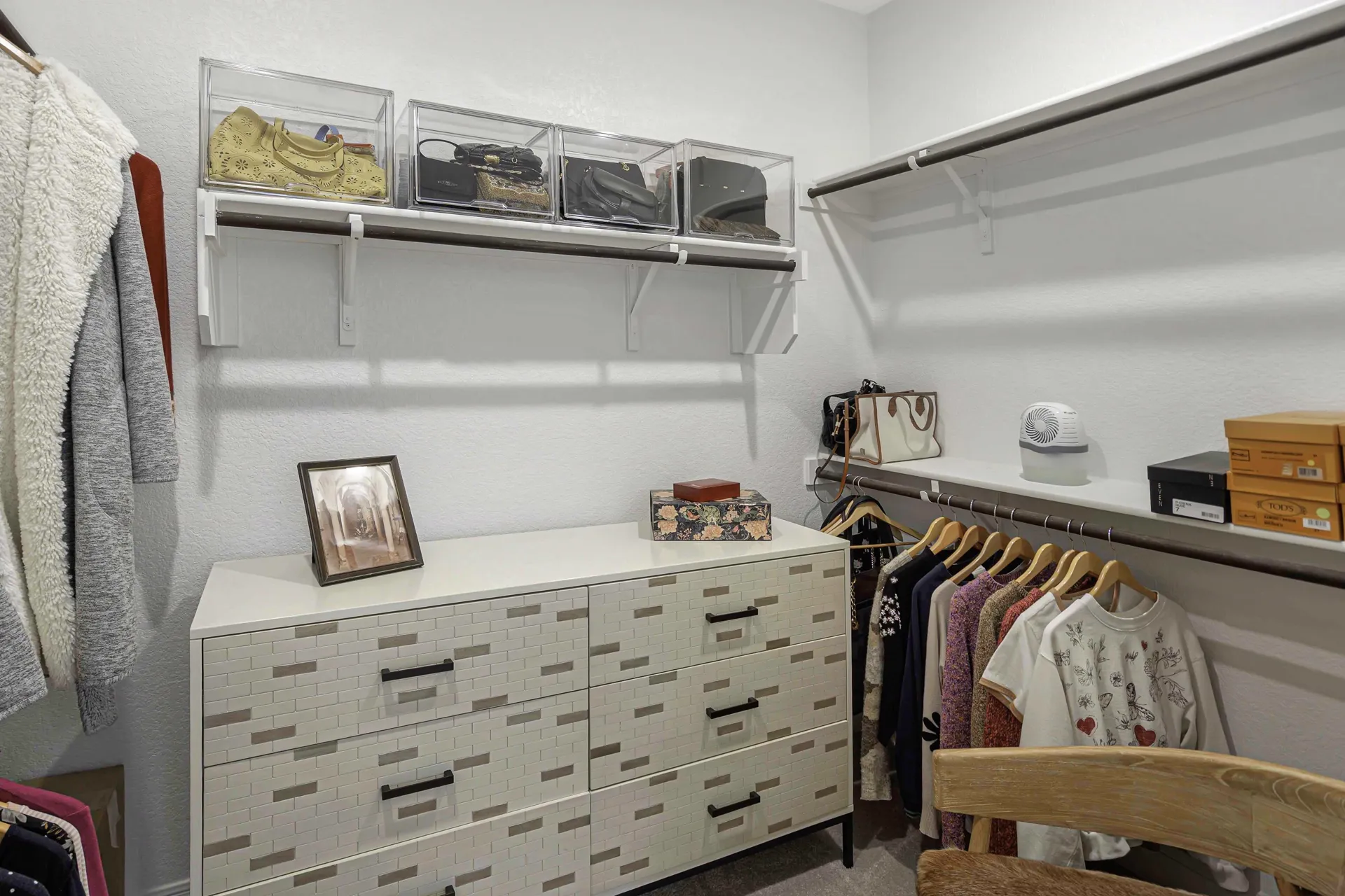 Primary closet — organized storage with custom shelving
