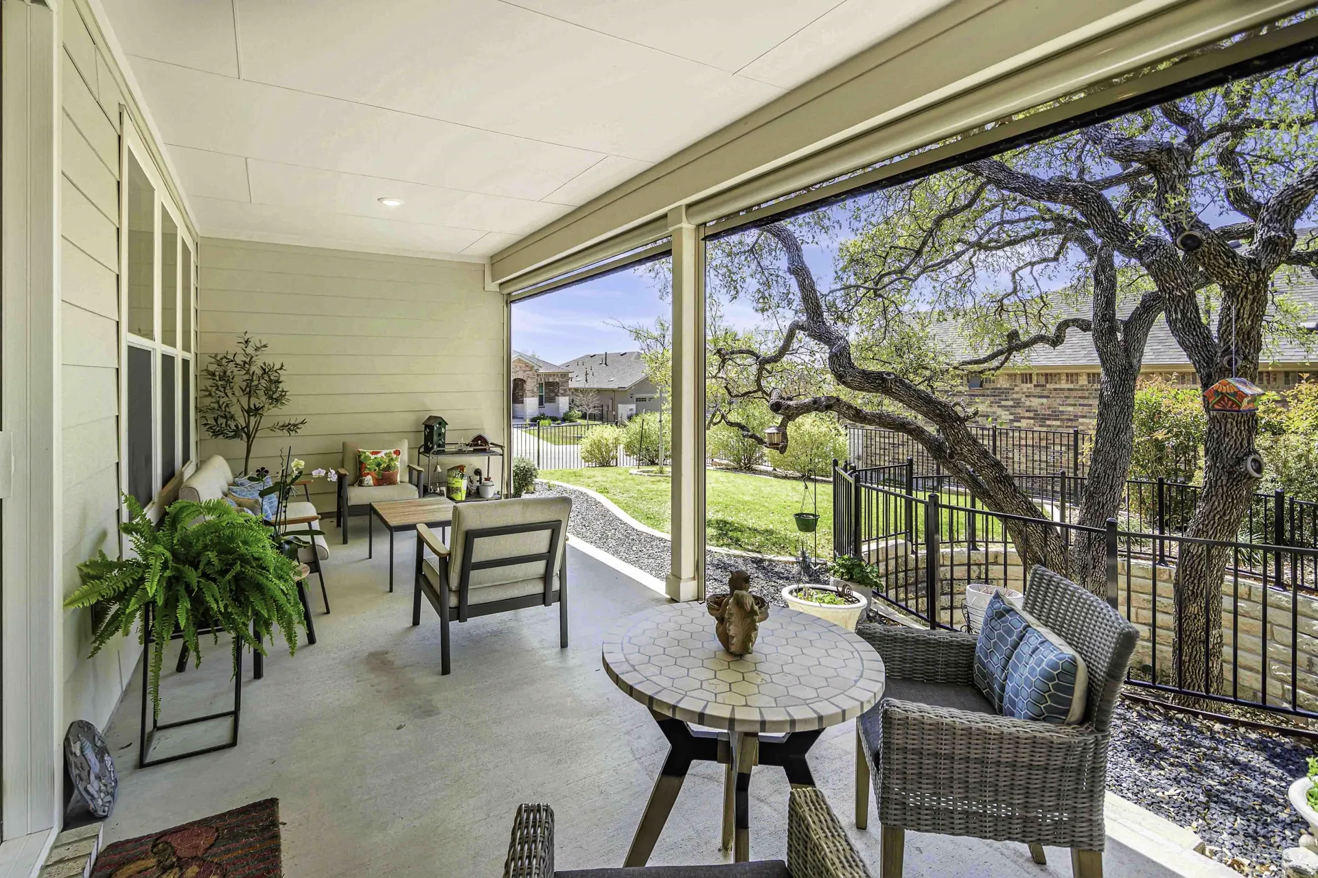 Backyard patio with scenic Hill Country view and mature oak trees